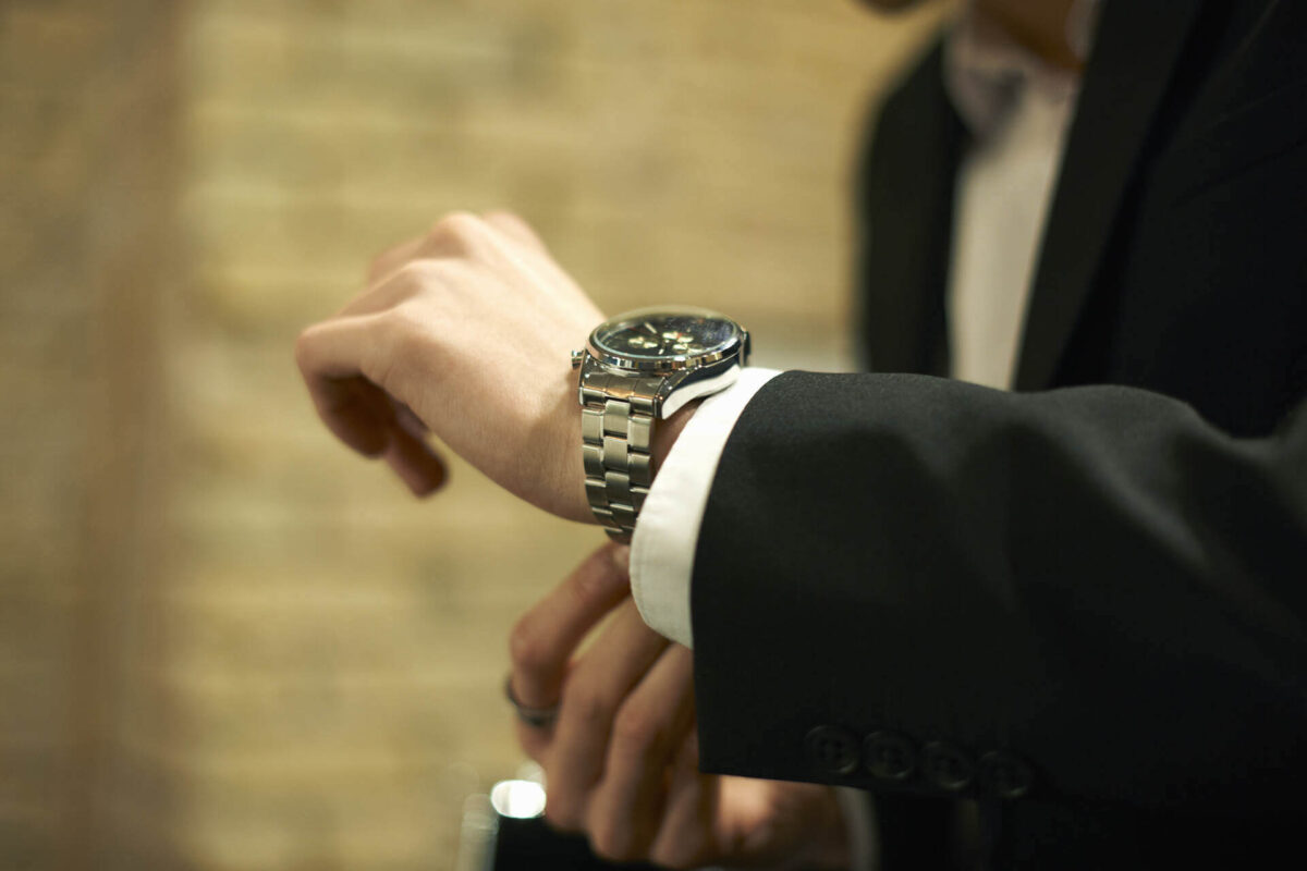 A man trying on one of the many different rolex styles available for sale at Wolvyn
